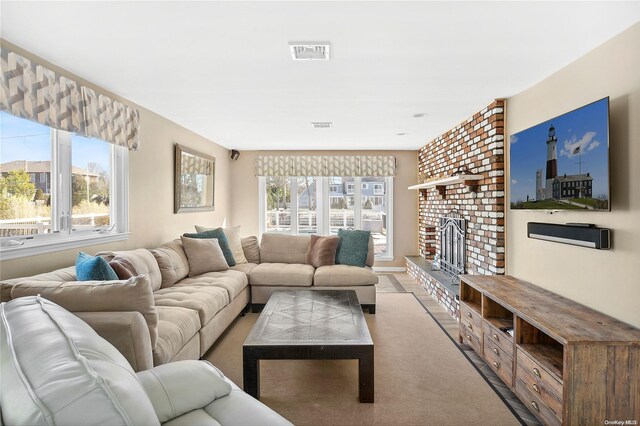 living room featuring a brick fireplace