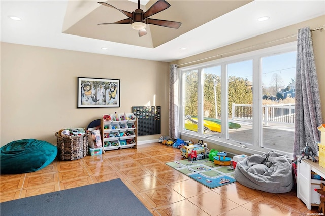 playroom with ceiling fan and light tile patterned floors