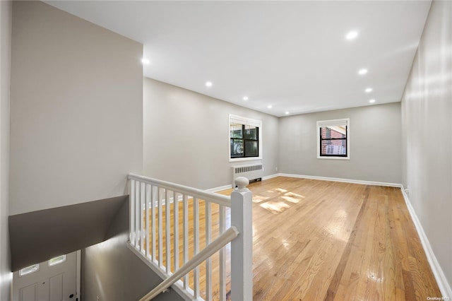 hall featuring radiator and wood-type flooring