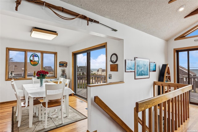 21 Captain Kidds Path, Montauk, NY 11954 - dining room featuring light wood-style floors, a textured ceiling, lofted ceiling, and recessed lighting