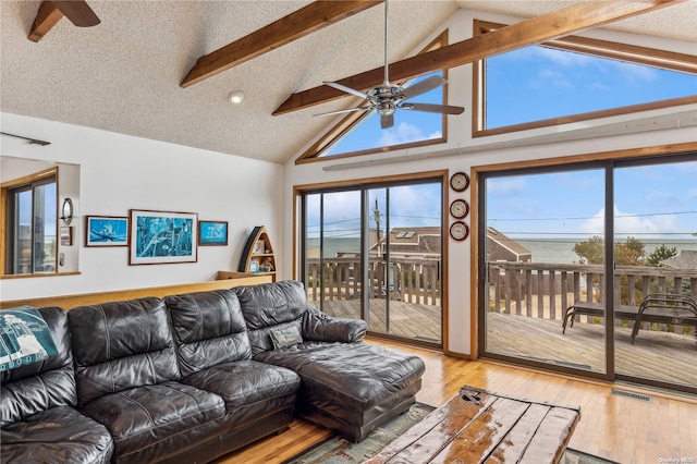 21 Captain Kidds Path, Montauk, NY 11954 - living area with a ceiling fan, wood finished floors, beamed ceiling, and high vaulted ceiling