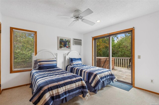 bedroom featuring carpet, an AC wall unit, ceiling fan, access to exterior, and a textured ceiling