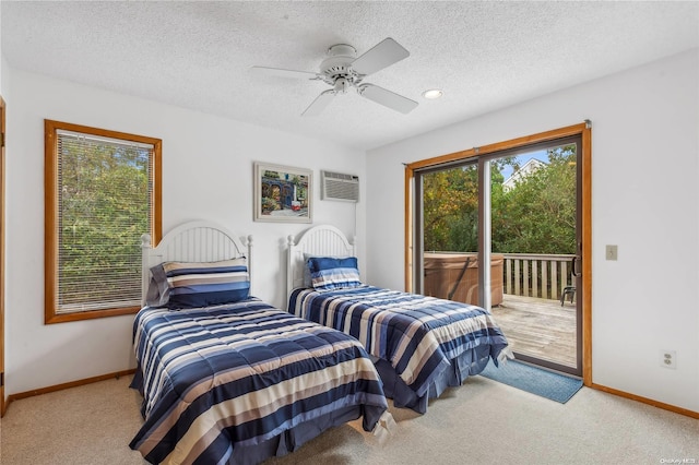 21 Captain Kidds Path, Montauk, NY 11954 - bedroom with access to outside, carpet flooring, a wall mounted air conditioner, a textured ceiling, and a ceiling fan