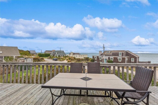 wooden terrace featuring a water view