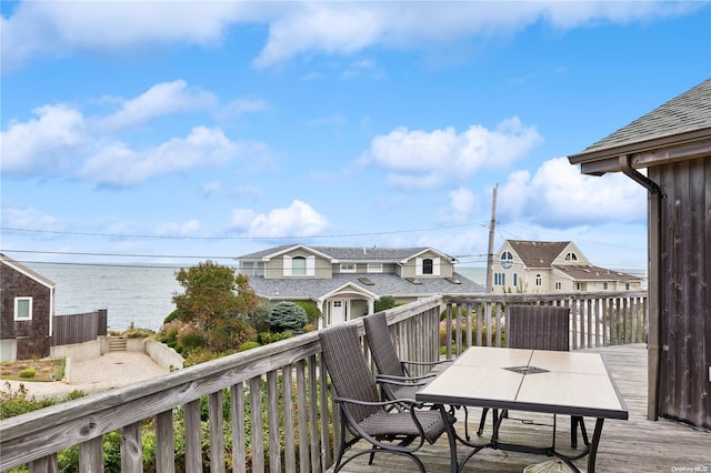 21 Captain Kidds Path, Montauk, NY 11954 - wooden deck with outdoor dining area and a residential view