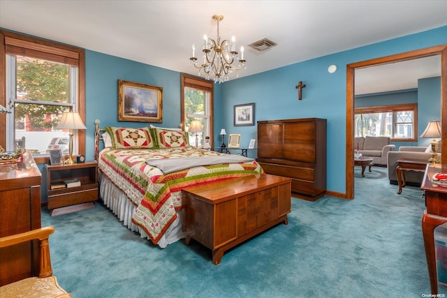 carpeted bedroom featuring a notable chandelier