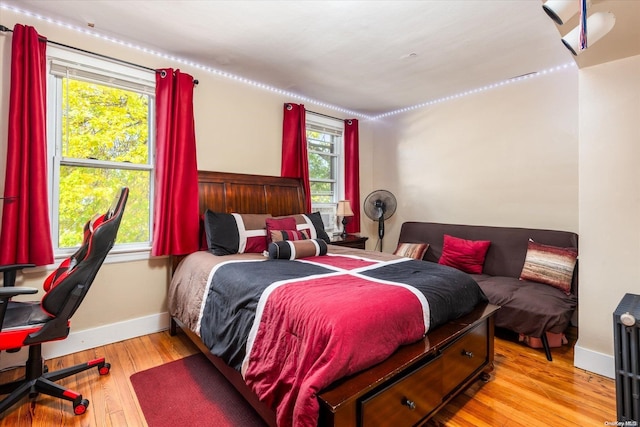 bedroom featuring light hardwood / wood-style floors and multiple windows