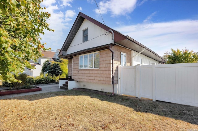 view of side of home with a lawn