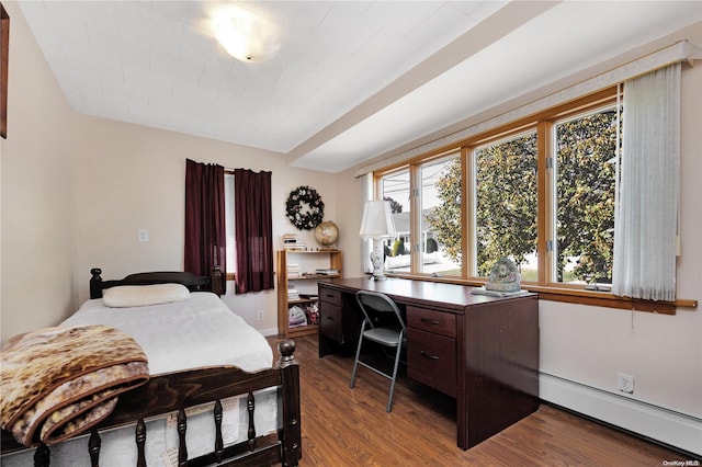 bedroom with baseboard heating and wood-type flooring