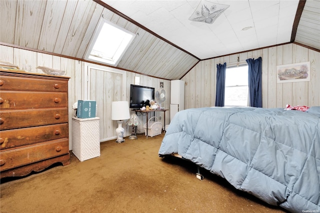 carpeted bedroom featuring ornamental molding, wood walls, and vaulted ceiling with skylight