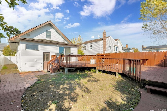 back of house with a wooden deck