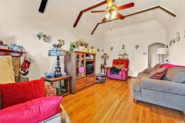 living room featuring ceiling fan, hardwood / wood-style floors, and high vaulted ceiling