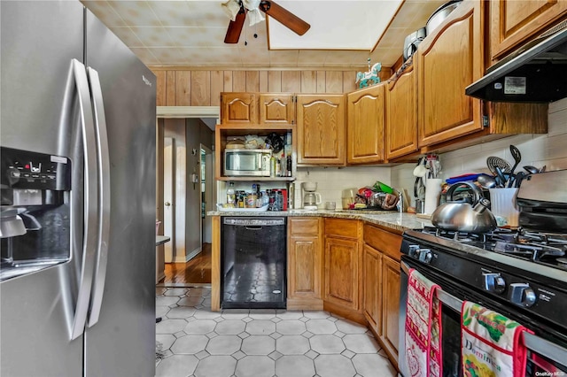 kitchen with ceiling fan, decorative backsplash, light stone countertops, appliances with stainless steel finishes, and extractor fan