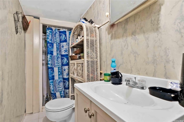 bathroom featuring tile patterned flooring, vanity, and toilet