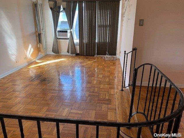 unfurnished room featuring cooling unit and parquet flooring