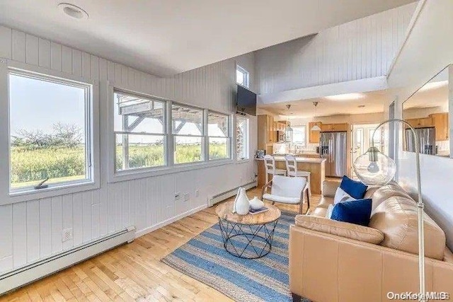 living room featuring a baseboard radiator and light hardwood / wood-style floors