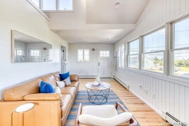 living room featuring light hardwood / wood-style flooring and a baseboard heating unit