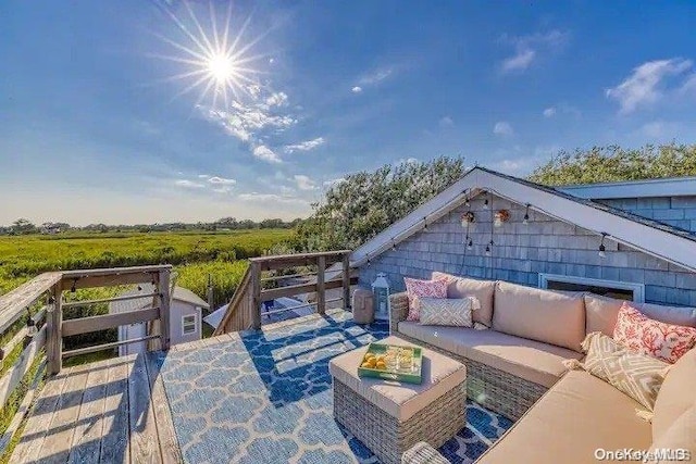 exterior space with outdoor lounge area and a rural view