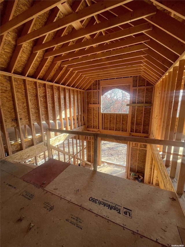 misc room with a healthy amount of sunlight and vaulted ceiling