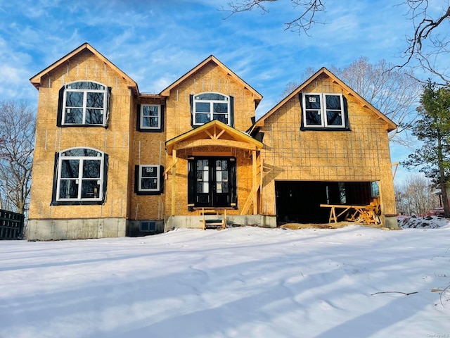 view of front of home with a garage and french doors