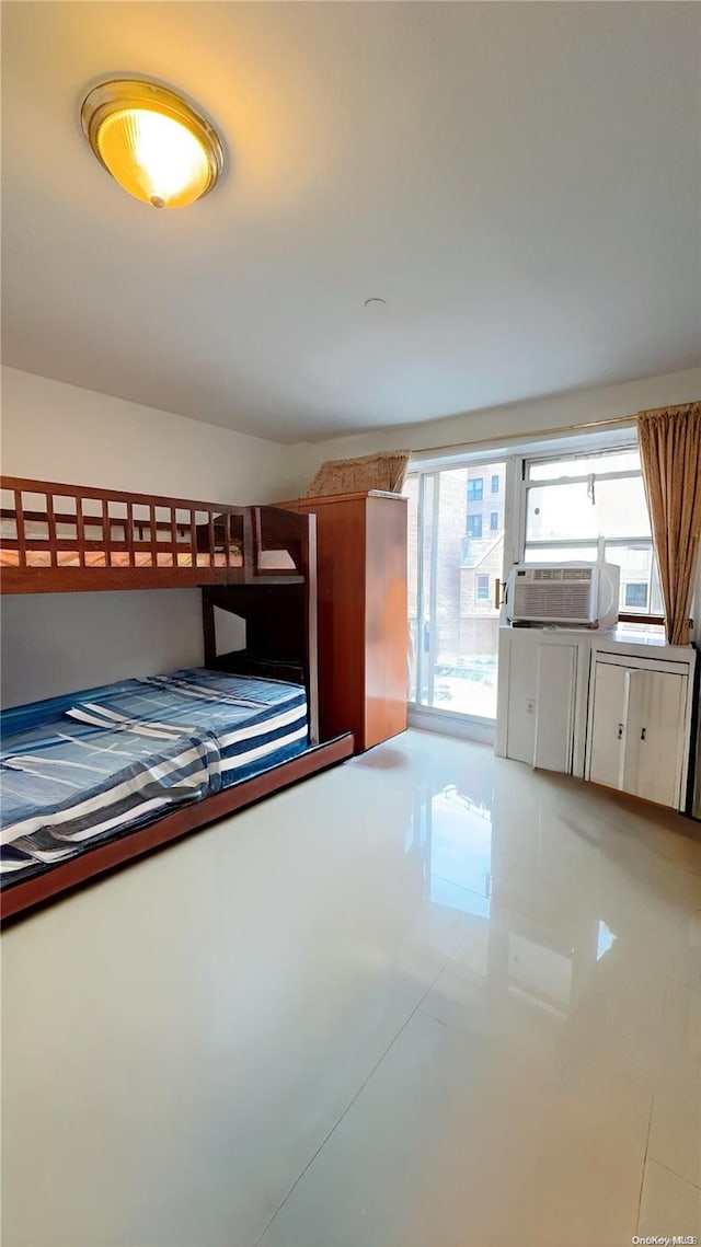 unfurnished bedroom featuring tile patterned floors and cooling unit