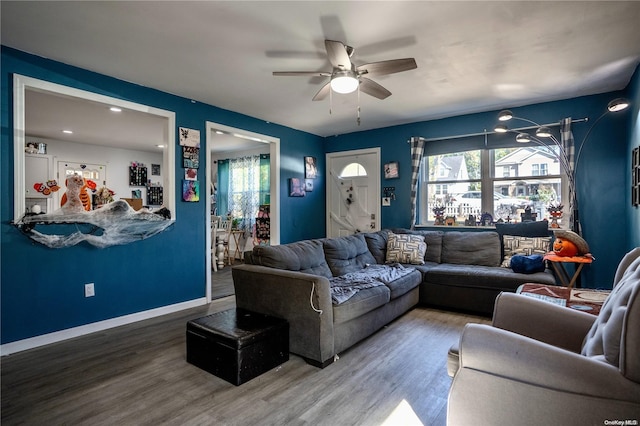 living room with hardwood / wood-style flooring and ceiling fan