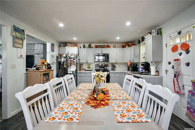 dining space with sink and dark hardwood / wood-style floors