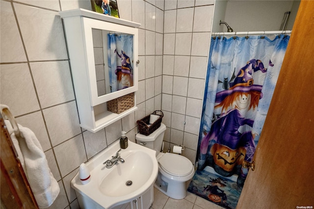 bathroom with tile patterned flooring, toilet, tile walls, and sink