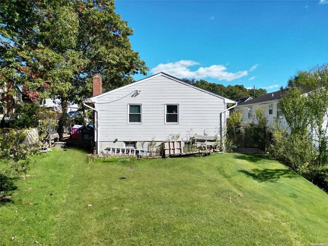 rear view of property featuring a yard