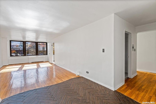 spare room featuring dark wood-type flooring