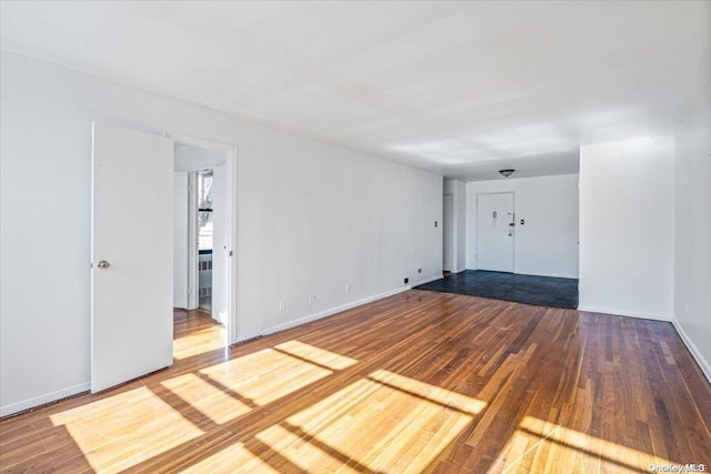 empty room with hardwood / wood-style flooring