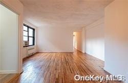 spare room with hardwood / wood-style floors