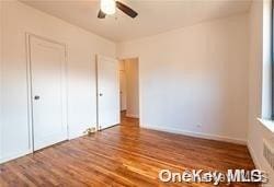 unfurnished bedroom featuring wood-type flooring and ceiling fan