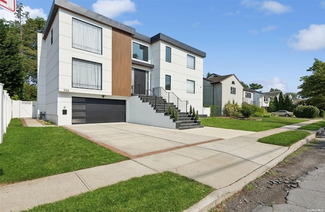 view of front facade with a front yard and a garage