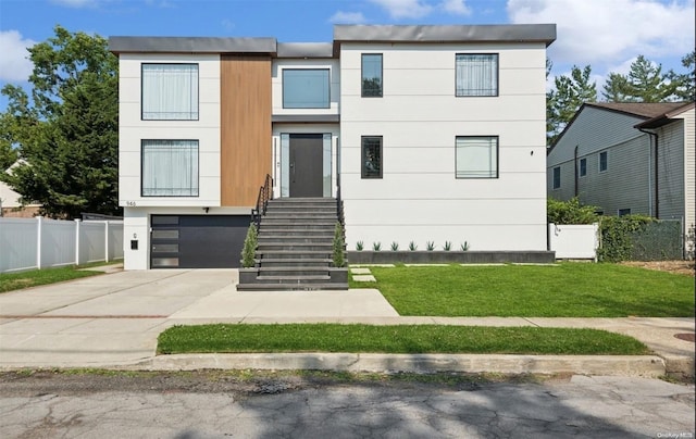 view of front of house with a garage and a front yard