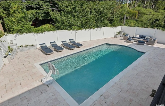 view of pool with outdoor lounge area and a patio