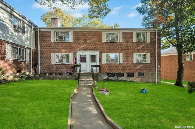 view of front of property featuring cooling unit and a front lawn