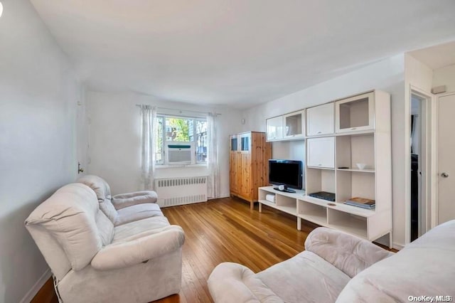 living room with light wood-type flooring and radiator