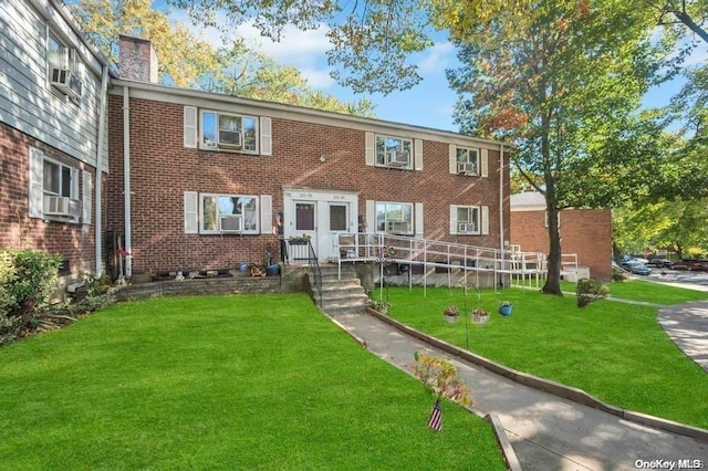 view of front of home featuring a front lawn and cooling unit