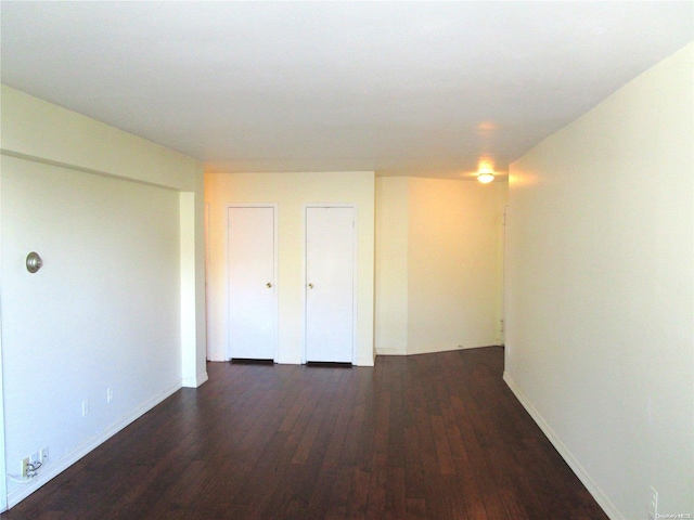 unfurnished room featuring dark hardwood / wood-style floors