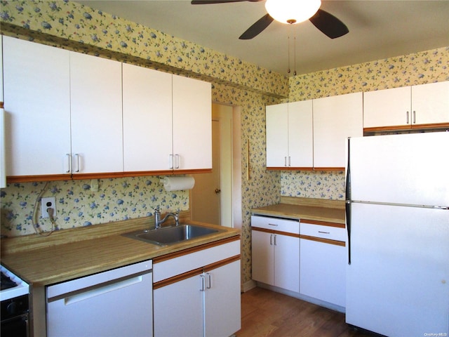 kitchen featuring ceiling fan, sink, white cabinets, and white appliances