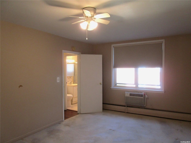 unfurnished bedroom with ensuite bath, light colored carpet, a wall mounted AC, ceiling fan, and a baseboard radiator