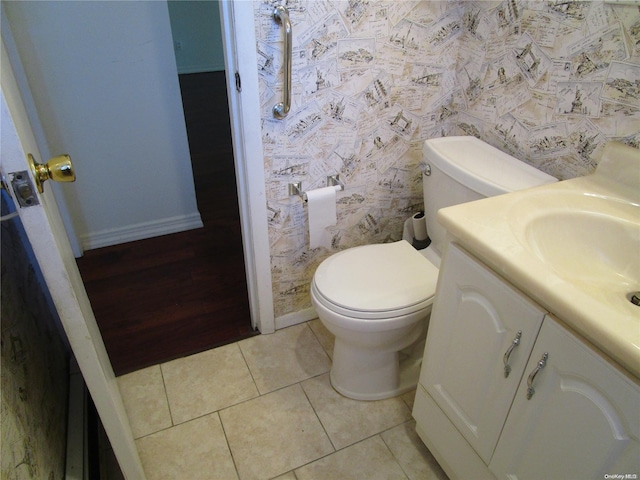 bathroom featuring tile patterned floors, vanity, and toilet