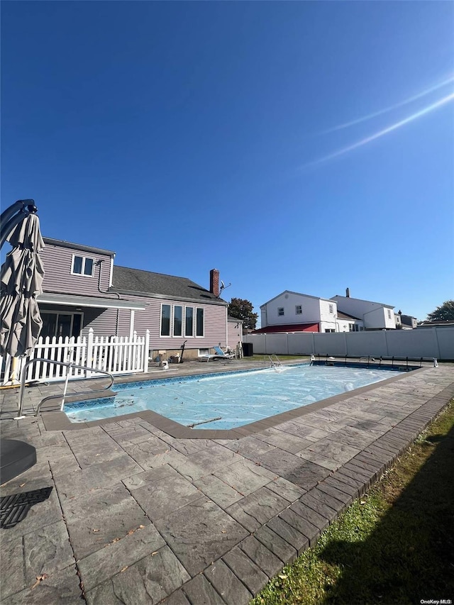 view of swimming pool featuring a patio