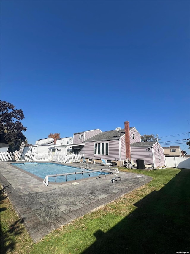 view of swimming pool with a patio area and a yard