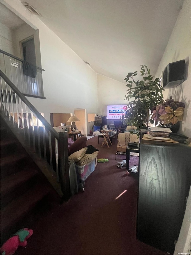 carpeted living room with lofted ceiling