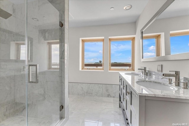 bathroom with vanity and a shower with shower door