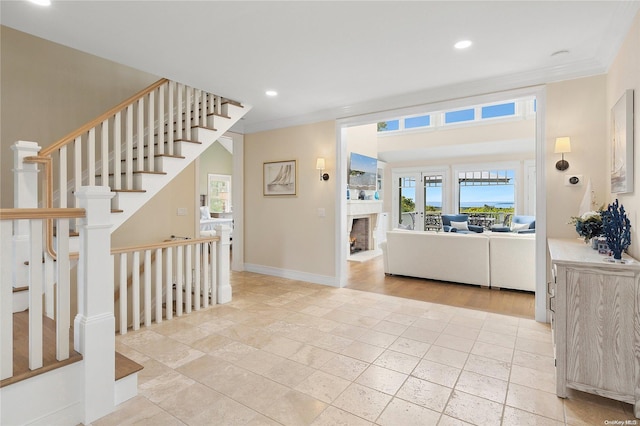 foyer entrance featuring crown molding