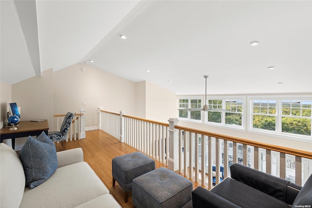 interior space with light wood-type flooring and vaulted ceiling