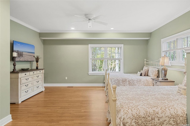 bedroom with multiple windows, light wood-type flooring, ceiling fan, and crown molding